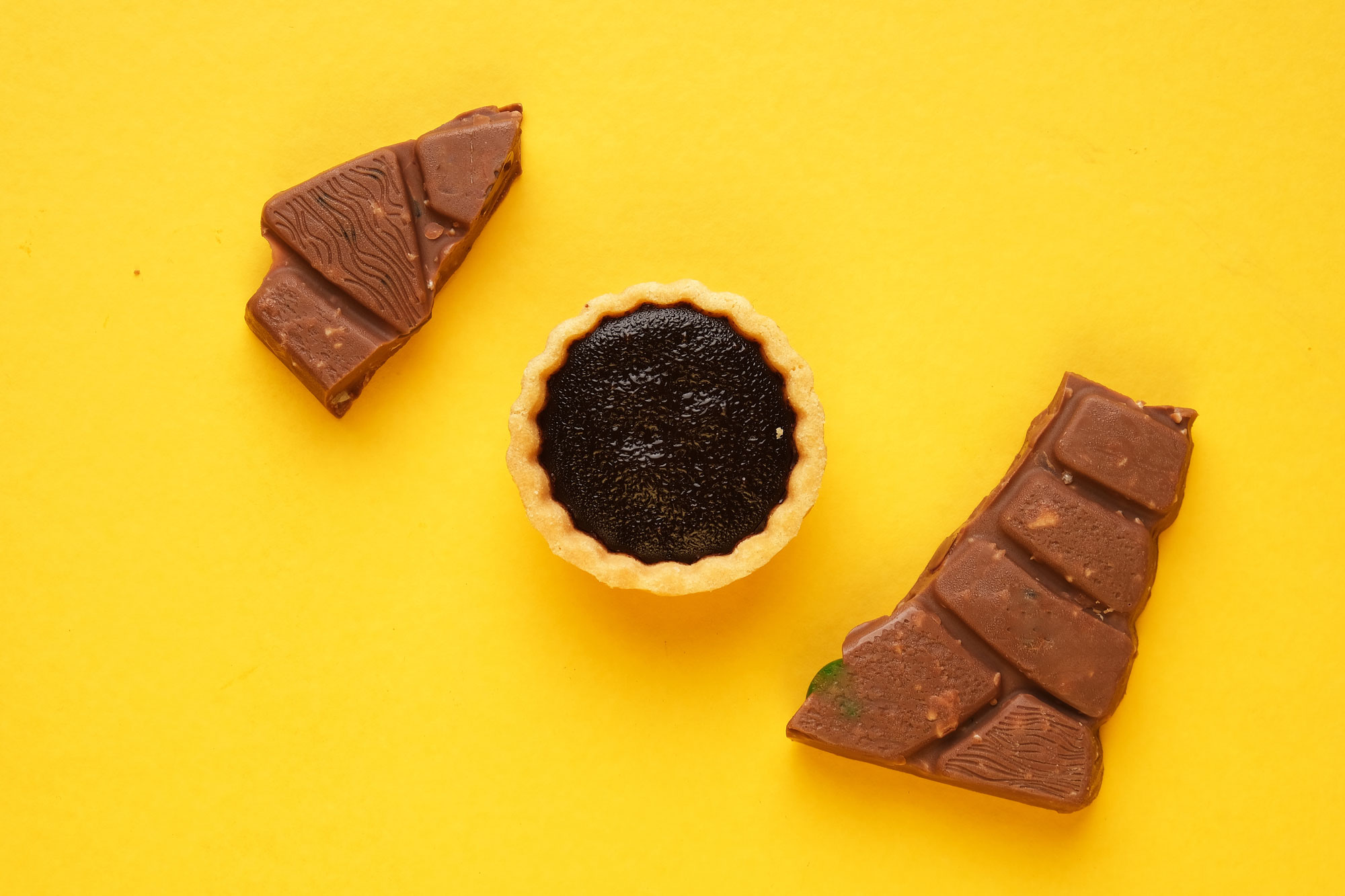 a-picture-of-4-chocolate-tart-and-bar-on-yellow-ba-2022-05-18-07-19-27-utc