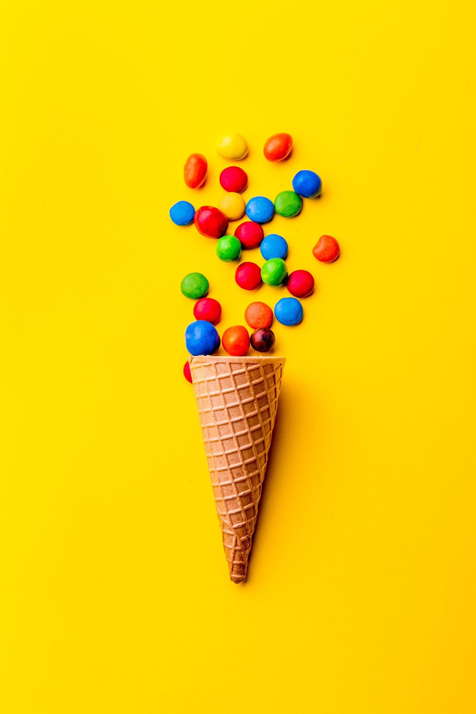 ice-creame-cone-with-candy-on-yellow-background-m-2021-08-28-14-46-31-utc